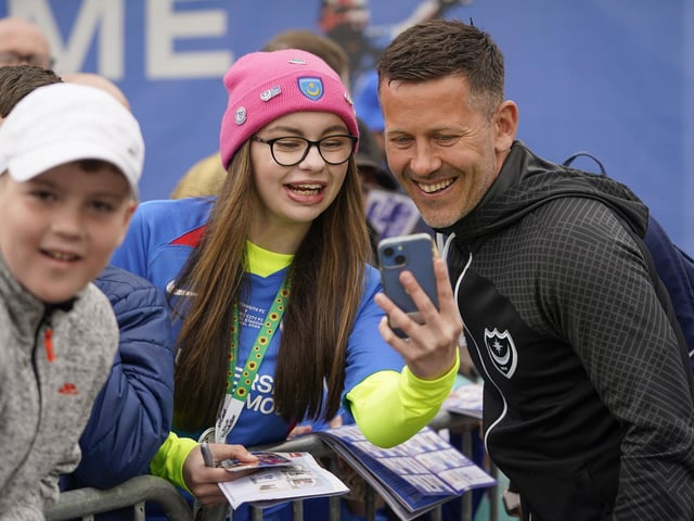 Assistant head coach Jon Harley stops for a selfie with this young Pompey fan