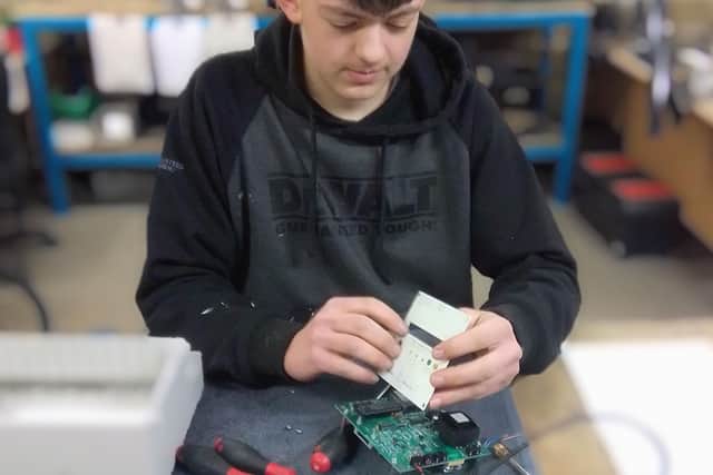 Dillon working on one of our clock controllers that automatically resets our clocks after power cuts and seasonal time changes.