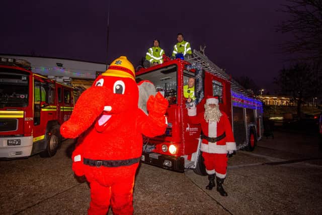 Portchester firefighters take out illuminated vintage engine to raise cash for Fire Fighters CharityPictured: Portchester firefighters with the illuminated vintage engine, their mascot and Santa at Portchester fire station on Friday 17th December 2021Picture: Habibur Rahman