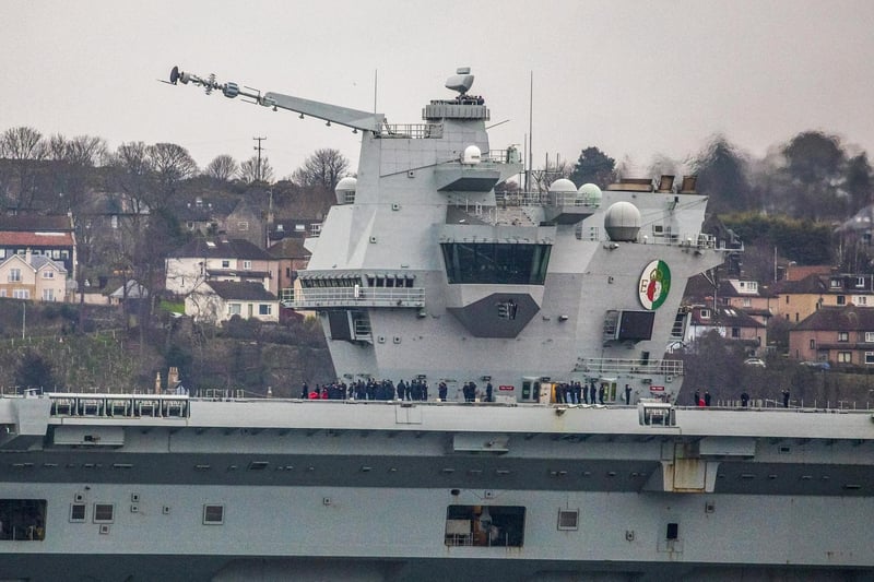 HMS Queen Elizabeth makes her way under the Forth Bridges as she prepares to dock at Rosyth dockyard for repairs, March 21 2024.