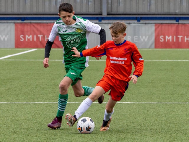 Action from the Under-13 Truman Challenge Cup final between Denmead Youth Lions (orange shirts) and Moneyfields Youth Yellow. Picture: Mike Cooter