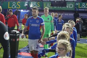 Gareth Evans leads Pompey out against Arsenal on Monday night - a game that saw several Arsenal players abandon the traditional pre-match handshake