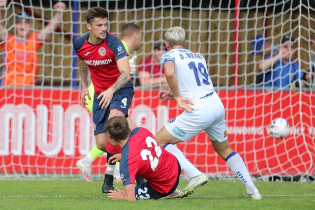 Danny Wright watches his header put Hawks 2-1 up at Hampton & Richmond. Picture by Dave Haines