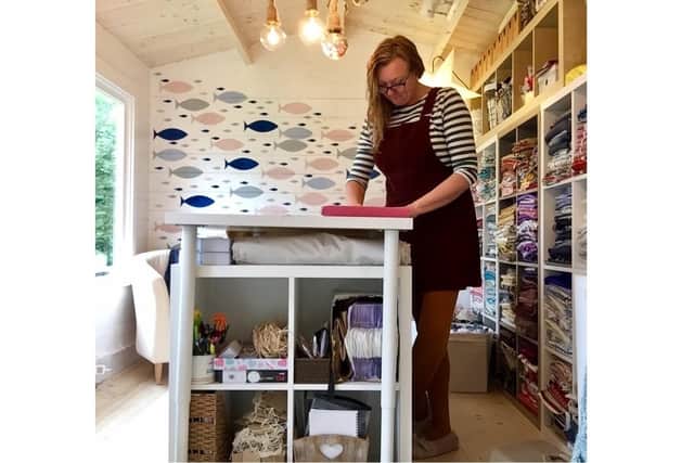 Jo Melton, from Stubbington, runs The Seaside Sew and has been creating face masks during lockdown to raise £500 for Mind mental health charity. Pictured: Jo working hard in her workshop