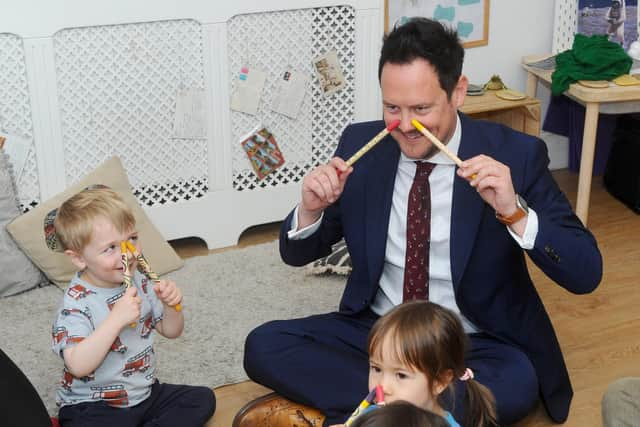 Stephen Morgan MP takes part in the Boogie Mites session at the opening of the Tops Day Nurseries Southsea in Bruce Road with, left, William Taylor, three
Picture: Sarah Standing (220422-2103)