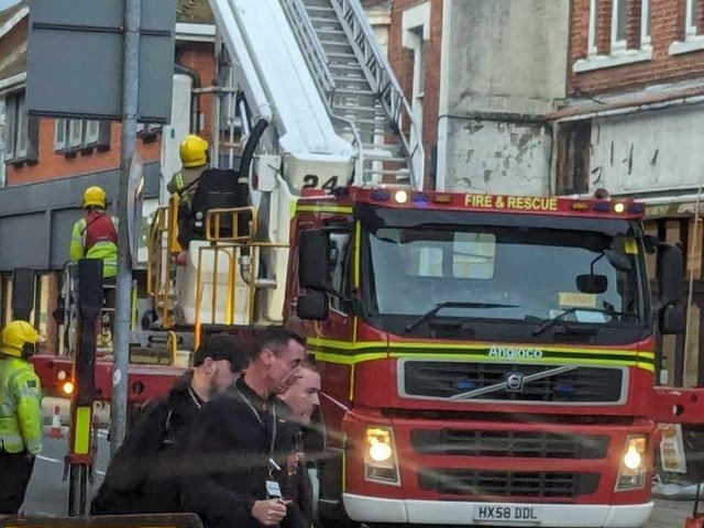 Firefighters fixing loose roof tiles and a sign above Poppins Cafe in North Street, Havant, on January 2.