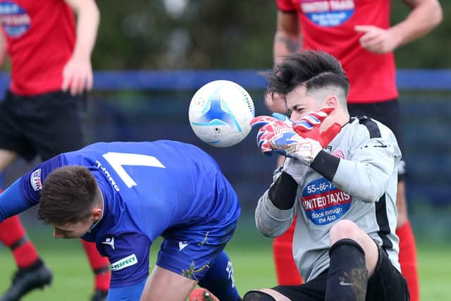 The Poppies goalkeeper fails to gather under pressure from Tommy Scutt. Picture: Chris Moorhouse.