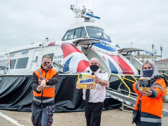 Picture shows (from left to right):  Craig Turner (Team Leader), Paul Grant (pilot) and Samantha Kloppers (crew) all from Hovertravel donating food for the Comfort and Joy campaign