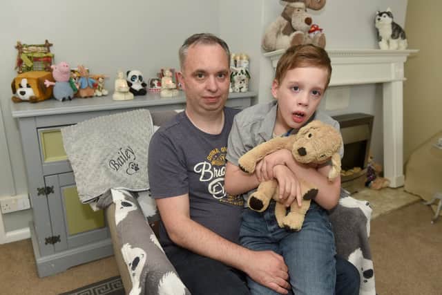 Preston Wallis, 11, and his dad Richard Wallis who are devastated after Bailey the dog was killed 
Picture: Sarah Standing (100622-9881)