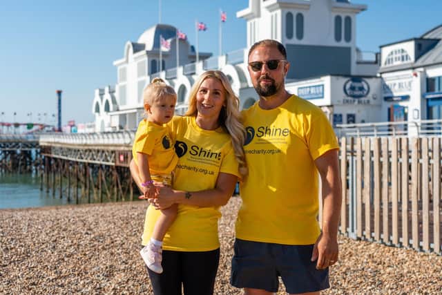 Carrie Groves (36), Esme (2), and Terry Groves (37) at South Parade Pier before setting off for their one mile charity walk.
