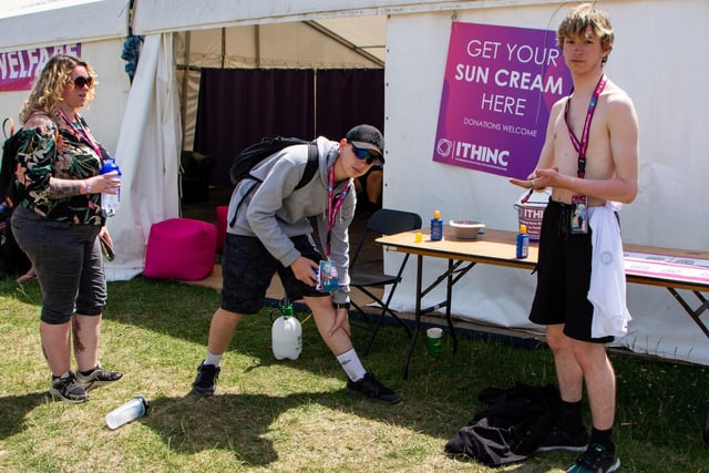 The Isle Of Wight Festival in Seaclose Park 2022. Pictured is: (l-r) Stef Winstanley, Joshua Winstanley-Thomas and Cairan Winstanley-Thomas from Swansea, take advantage of the free sunscreen. Picture: Emma Terracciano