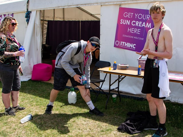 The Isle Of Wight Festival in Seaclose Park 2022. Pictured is: (l-r) Stef Winstanley, Joshua Winstanley-Thomas and Cairan Winstanley-Thomas from Swansea, take advantage of the free sunscreen. Picture: Emma Terracciano