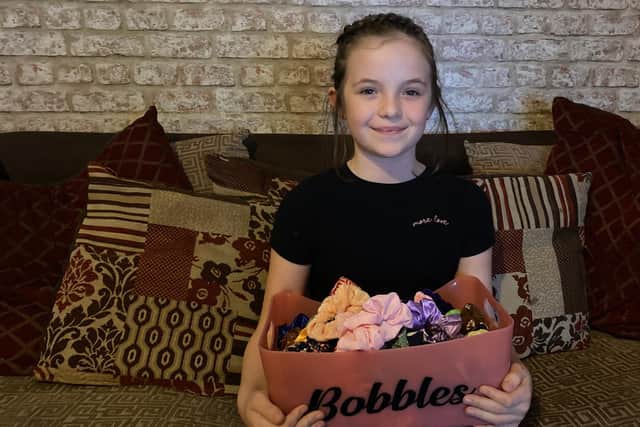 Isabelle Smith, 9 from Havant, has been making and selling scrunchies and raised funds for Children in Need. Pictured: Isabelle with a selection of her scrunchie creations