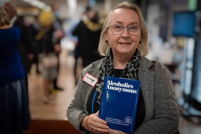 Lindy Elliot, the libraries and archives manager of Portsmouth Libraries, after being presented with the first copy of the The Alcoholics Anonymous "Big Book" to be placed into the library for people to read and borrow 
Picture: Andy Hornby