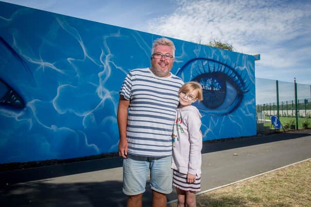 Artist, My Dog Sighs has finished painting his mural at Hilsea Lido on 23 July 2020.

Pictured: Fans of My Dog Sighs, Dean and his daughter Katie Nicholls 9 near the mural.

Picture: Habibur Rahman