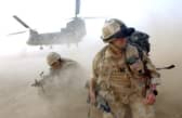 Sand and dust gets thrown up as No 3 Company the First Battalion The Grenadier Guards deploy out of an RAF Chinook Helicopter. Picture: Sergeant Will Craig/Crown Copyright