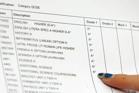 A close-up view of a piece of paper showing someone's GCSE results