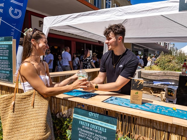 Charlotte Clark (27) gets an ice cold Pina Coloada from The Drift Bar stall. Picture: Mike Cooter (160722)