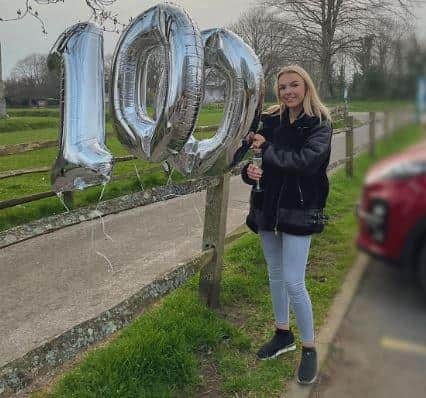 Ella Palmer, 18, celebrates completing her 100-mile walking challenge to raise money for the mental health charity Mind.