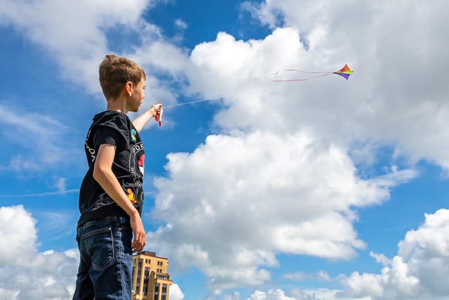 Owen Martin (11) making the most of the brisk seafront breeze at the Southsea Kite Festival. Picture: Mike Cooter (070821)