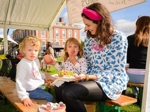 Pictured is: Abigail, Hope with Mum Hannah Mason tuck into some the lovely food at the Food Festival Picture: Keith Woodland (140921-20)