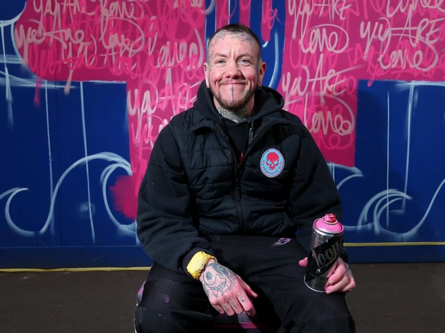 Mister Samo with his work You Are Loved. Picture: Chris Moorhouse (jpns 250223-20)
