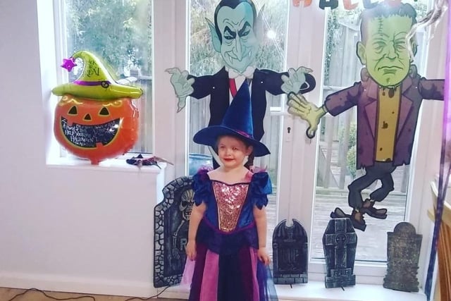 Isabella Rose Pepper, age 4, dressed as The Good Witch. We're loving the Halloween decorations!