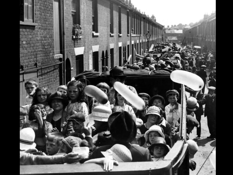 Somers Road North. Children in a fleet of charabancs during street traders day out.