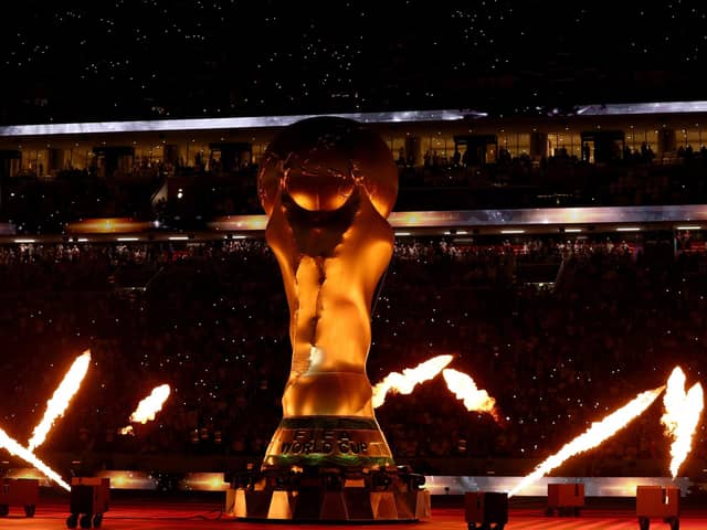 AL KHOR, QATAR - NOVEMBER 25: A fire display surrounds a giant FIFA trophy prior to the match between the United States and England during the FIFA World Cup Qatar 2022 Group B match between England and USA at Al Bayt Stadium on November 25, 2022 in Al Khor, Qatar. (Photo by Elsa/Getty Images)
