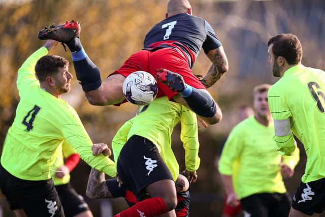 Bottoms up! Paulsgrove's Aaron Fennemore attempts to get on the end of a free-kick against Bush Hill. Picture: Chris Moorhouse