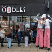 Stilt walkers handed out 50 per cent off vouchers for the opening day of Oodles in Commercial Road.Picture: Mike Cooter