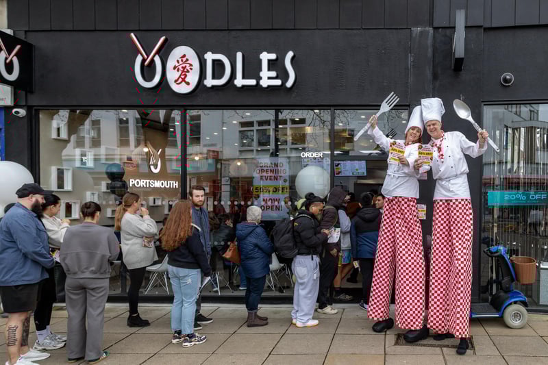 Stilt walkers handed out 50 per cent off vouchers for the opening day of Oodles in Commercial Road.Picture: Mike Cooter