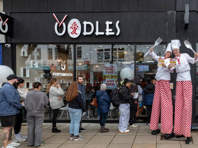 Stilt walkers handed out 50 per cent off vouchers for the opening day of Oodles in Commercial Road.Picture: Mike Cooter