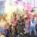 Students and staff celebrating worldwide culture with vibrant puffs of colour