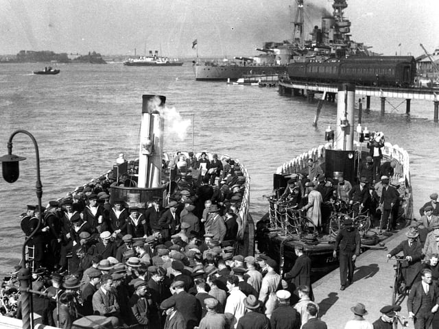 A packed Gosport Ferry in 1936. We see Dockyard men, sailors and ordinary folk boarding and alighting two Gosport Ferries.