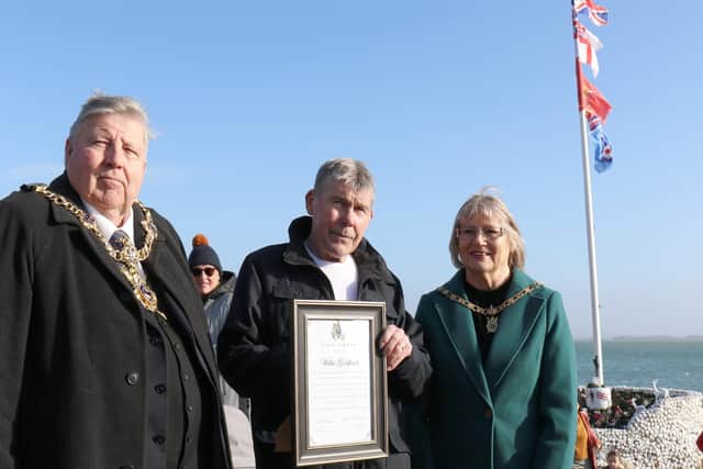 Willie Goldfinch, centre, pictured on Wednesday before Storm Eunice hit with Lord Mayor of Portsmouth Councillor Frank Jonas, left, and lady mayoress Mrs Joy Maddox, right, Willie was receiving a civic award for his work setting up and tending to the Peoples' Memorial in Portsmouth. Photo: Phix-Pix Photo and Graphic Solutions www.phix-pix.com
