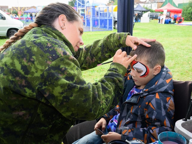Pictured is: Leanna Hassan paints a Spiderman design on Ryan Walker, 6.
Picture: Keith Woodland (070921-23)