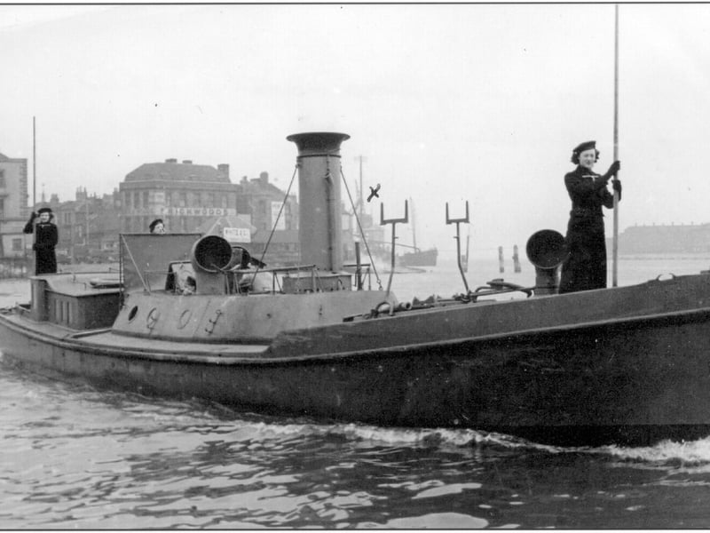 HMS Vernon steam picket boat, crewed by Wrens, near the entrance to Portsmouth Harbour. Point, Old Portsmouth, is visible in the background. One of a group of five photographs of Wrens (members of the Women's Royal Naval Service or WRNS) serving in Portsmouth taken a few weeks before D-Day. Wrens did not go to sea in WW2 but they played many supporting roles, mostly on land but some in boats like this.