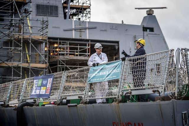 Dockyard staff working on board HMS Duncan during the Covid-19 lockdown at Portsmouth Naval Base. Photo: BAE Systems/Julian Hickman