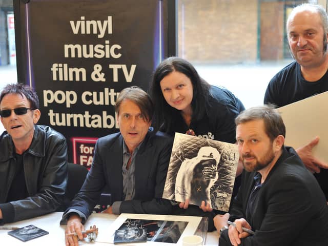 Suede doing an instore signing session at HMV in Commercial Road, Portsmouth with fans Sally and Andy Cornish from Southsea