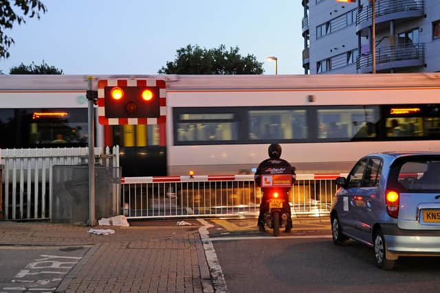 Traffic waits at the road crossing beside Cosham Railway Station
Picture: Malcolm Wells (132474-1475)