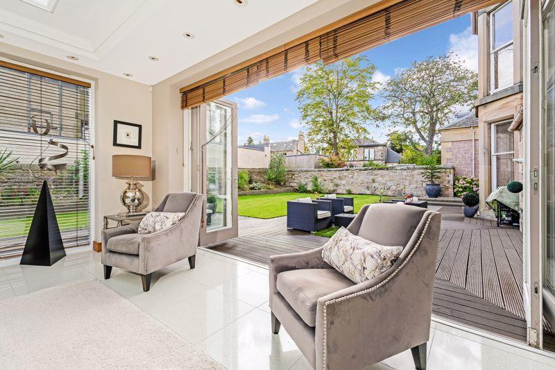 Bi-folding glass doors lead directly from the lounge onto the south facing gardens.