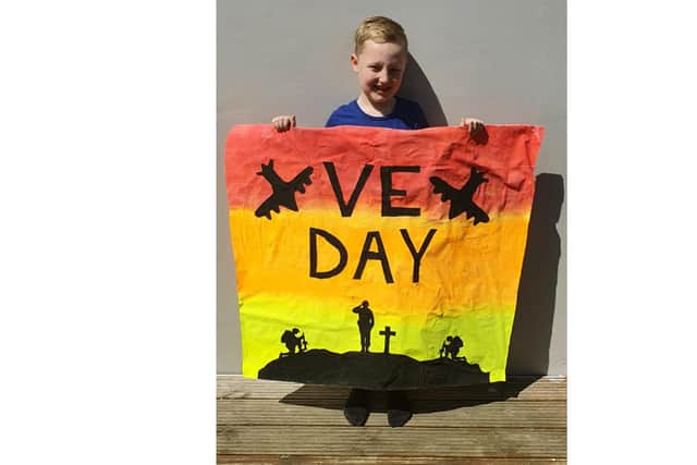 Ryan Chivers, 8, designed his own VE Day banner to display outside his house