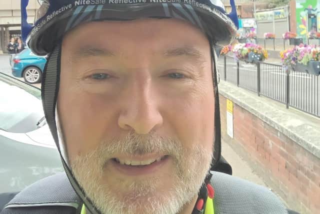 Peter Holland, CAP Area Manager pedalling past Portsmouth during Pedalling Against Poverty month