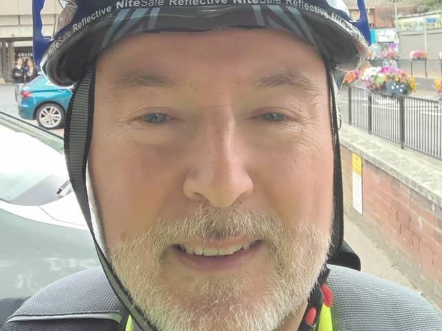 Peter Holland, CAP Area Manager pedalling past Portsmouth during Pedalling Against Poverty month