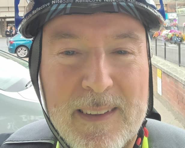 Peter Holland, CAP Area Manager pedalling past Portsmouth during Pedalling Against Poverty month