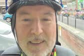 Peter Holland, CAP Area Manager pedalling past Portsmouth during Pedalling Against Poverty month