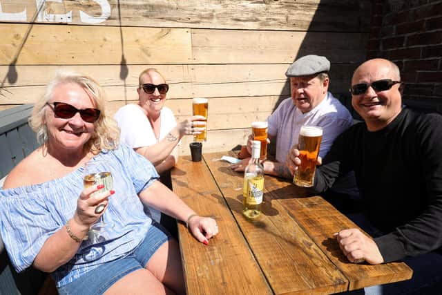 From left, Netty Higginbotham, Michelle Smith, Michael Higginbotham and Chris Smith. Drinkers enjoy the sunshine at the Prince of Wales, HavantPicture: Chris Moorhouse (jpns 240421-28)