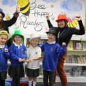Moorings Way Infant School - Executive Headteacher Sara Paine (L) and Head of MWIS Ruth Vonk (R) celebrate the school's accreditation with children.
Picture: Samuel Poole