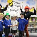 Moorings Way Infant School - Executive Headteacher Sara Paine (L) and Head of MWIS Ruth Vonk (R) celebrate the school's accreditation with children.
Picture: Samuel Poole